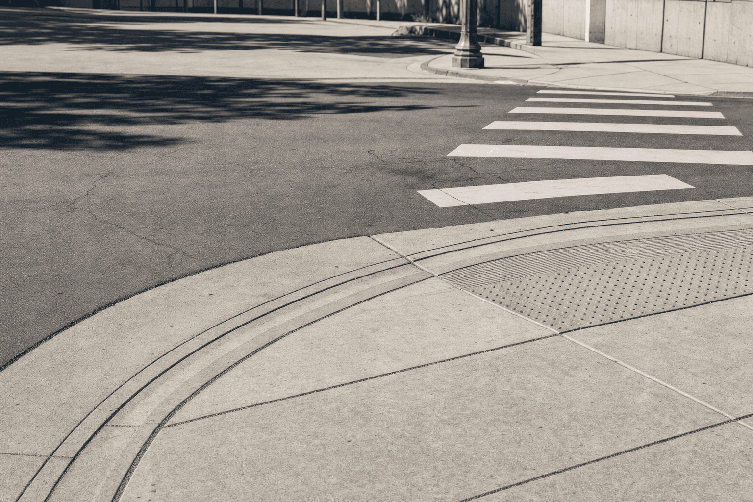 Daylight crosswalk and curb detail at a California intersection